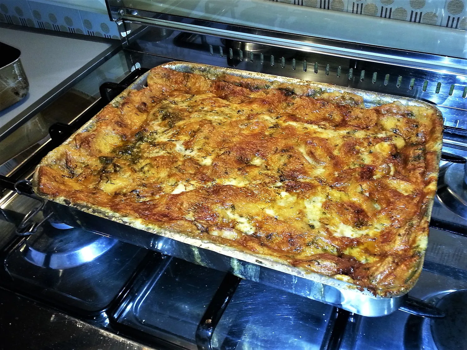 Una teglia di zuppa gallurese gratinata appena uscita dal forno